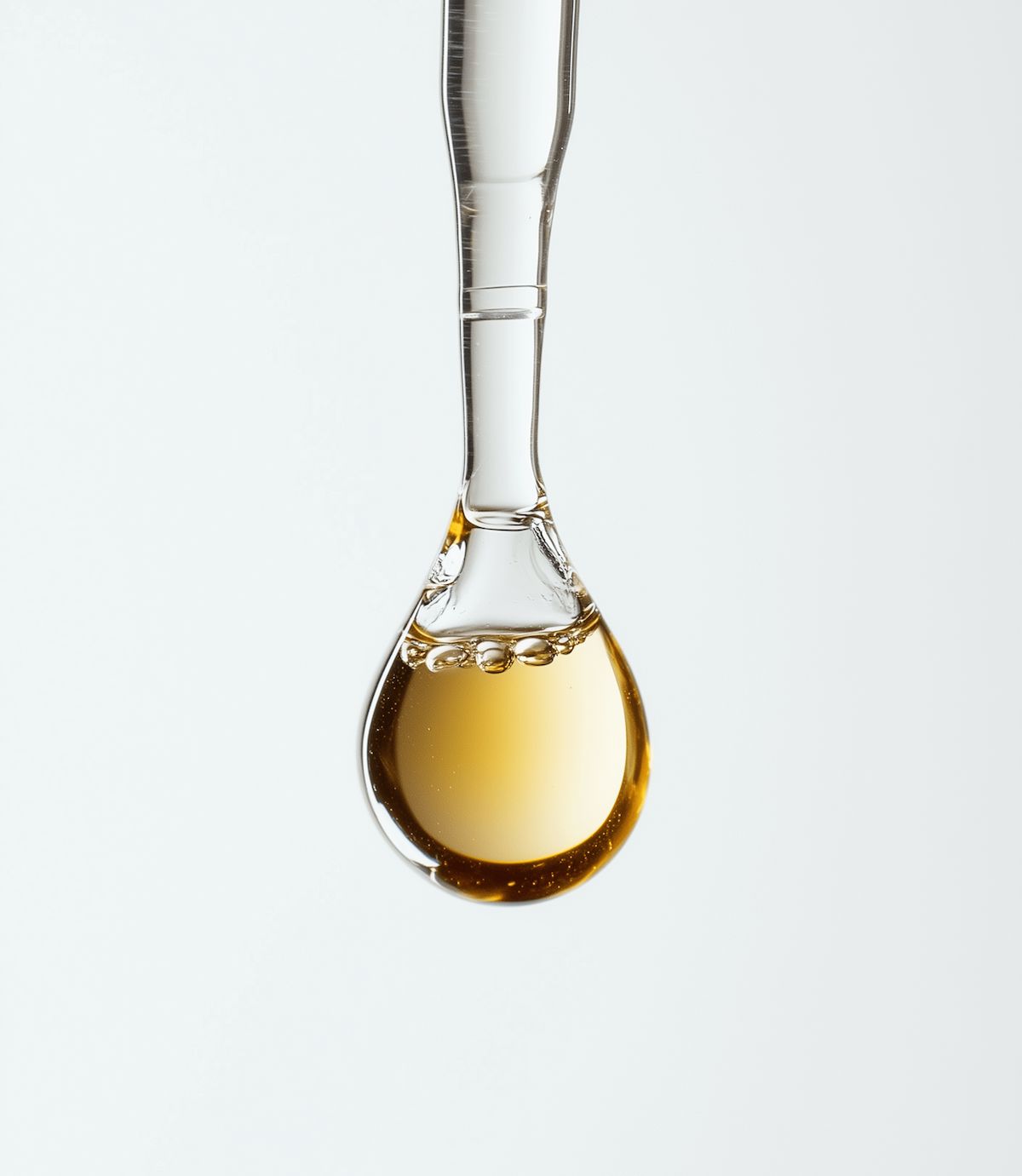 Glass dropper with a drop of liquid polyextract mushroom supplement